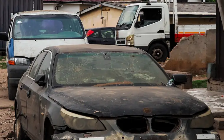 Accident damaged vehicle being recovered onto a flatbed truck