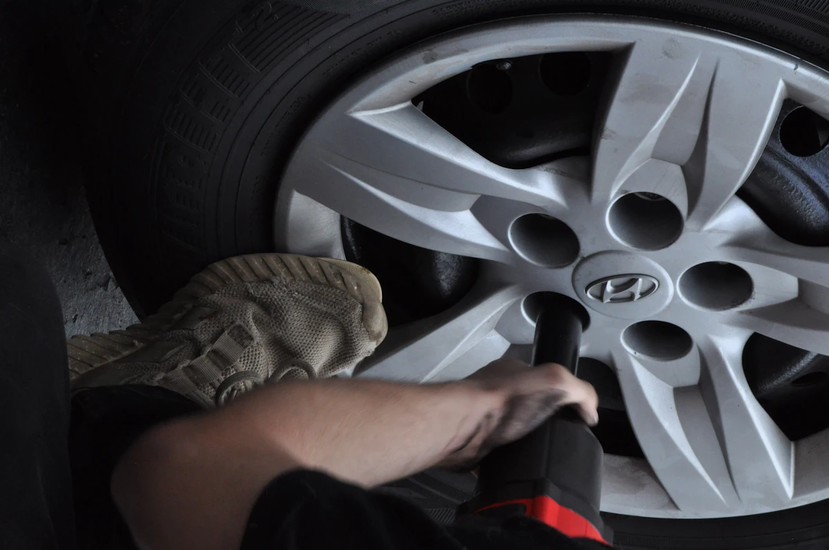 Technician changing a flat tyre at the roadside