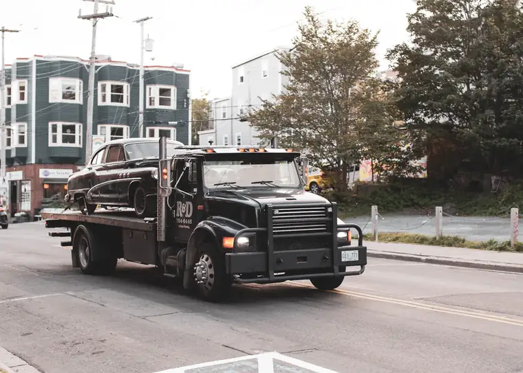 Motorcycle secured on a recovery truck bed
