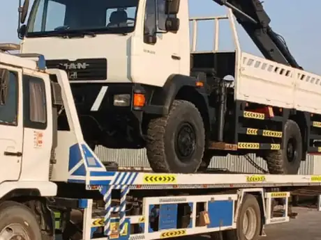 Heavy duty recovery truck carrying a crane vehicle — MZ Meer Car Recovery